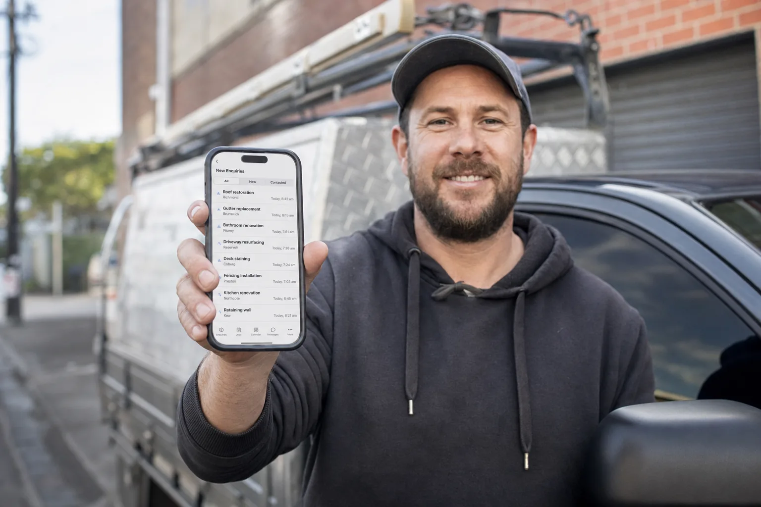 Melbourne business owner beside their ute taking a new exclusive enquiry on a phone