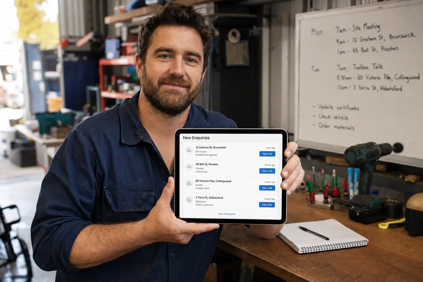 Melbourne tradesperson reviewing new enquiries on a tablet at their workbench